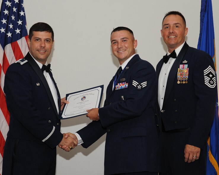 Senior Airman Duffy Freese, 2nd Maintenance Group, receives an Airman Leadership School graduation certificate from Col. Andrew Gebara, 2nd Bomb Wing commander, during the ALS Class 14-5 Graduation on Barksdale Air Force Base, La., June 19, 2014. (U.S. Air Force photo/Senior Airman Benjamin Gonsier)