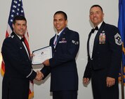 Senior Airman Joshua Compehos, 2nd Aircraft Maintenance Squadron, receives an Airman Leadership School graduation certificate from Col. Andrew Gebara, 2nd Bomb Wing commander, during the ALS Class 14-5 Graduation on Barksdale Air Force Base, La., June 19, 2014. (U.S. Air Force photo/Senior Airman Benjamin Gonsier)
