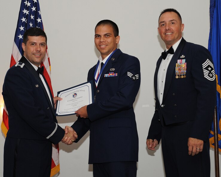 Senior Airman Joshua Compehos, 2nd Aircraft Maintenance Squadron, receives an Airman Leadership School graduation certificate from Col. Andrew Gebara, 2nd Bomb Wing commander, during the ALS Class 14-5 Graduation on Barksdale Air Force Base, La., June 19, 2014. (U.S. Air Force photo/Senior Airman Benjamin Gonsier)