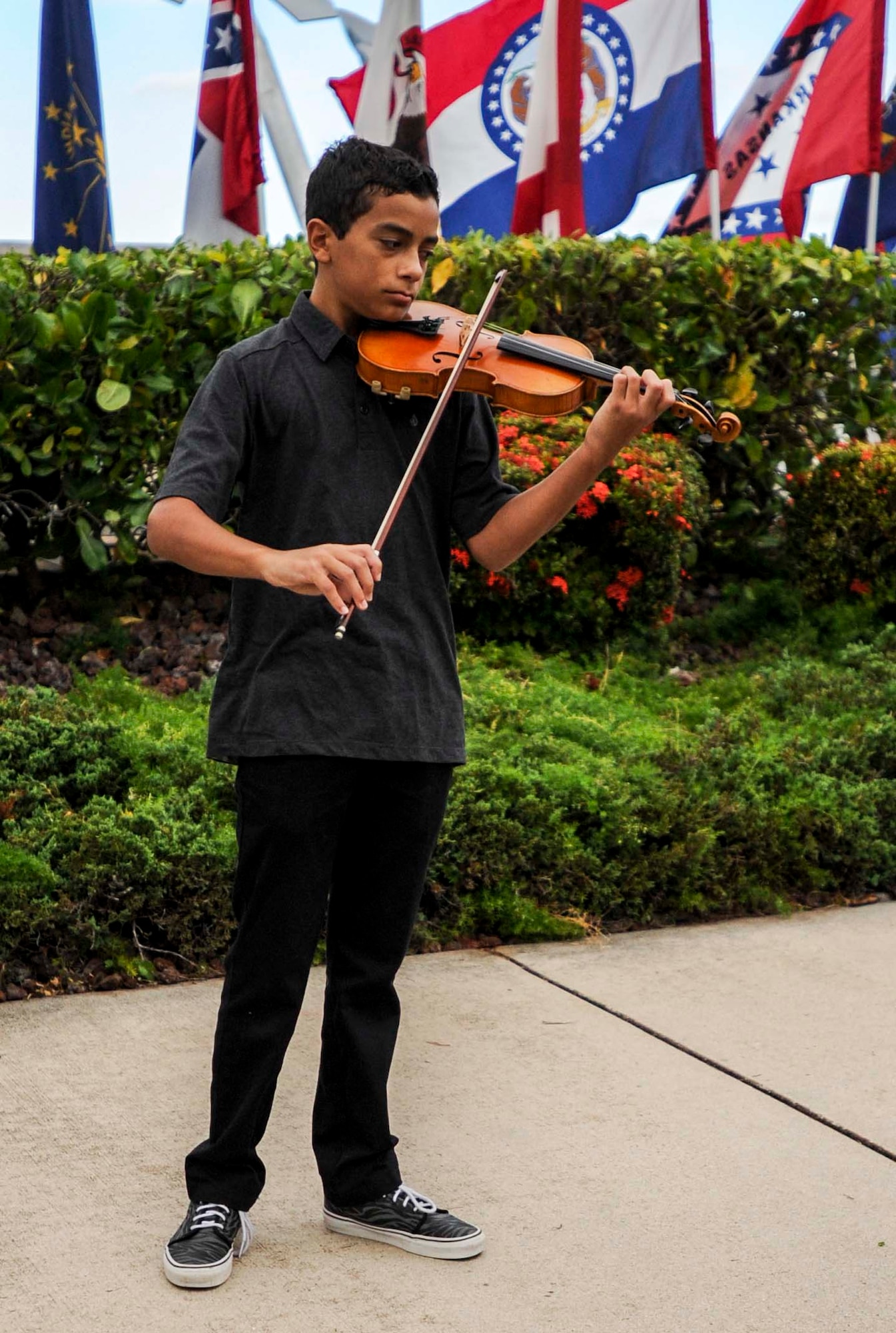 Ethan Hillman, 13, plays the national anthem on a violin during the 747th Communications Squadron change of command ceremony at the Missing Man Formation on Joint Base Pearl Harbor-Hickam, Hawwaii, June 26, 2014. During the ceremony, Guimarin took the reins from Lt. Col. David Hillman. (U.S. Air Force photo/Tech. Sgt. Terri Paden)
