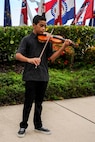 Ethan Hillman, 13, plays the national anthem on a violin during the 747th Communications Squadron change of command ceremony at the Missing Man Formation on Joint Base Pearl Harbor-Hickam, Hawwaii, June 26, 2014. During the ceremony, Guimarin took the reins from Lt. Col. David Hillman. (U.S. Air Force photo/Tech. Sgt. Terri Paden)