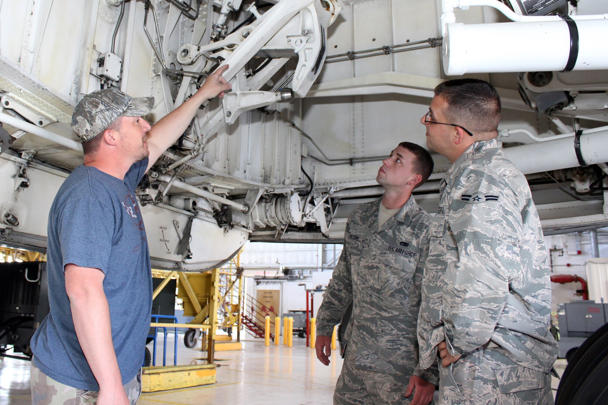 From left to right, Master Sgt. Matthew Cook, 512th Aircraft Maintenance Squadron crew chief and air reserve technician, trains Airman 1st Class Donald Williams and Airman 1st Class Aaron Hurley, both 512th AMXS crew chiefs, about components of the front landing gear on the C-5M Super Galaxy aircraft at Dover Air Force Base, Del., June 20, 2014. The 512th Airlift Wing currently has vacancies for the crew chief career field. Interested applicants can contact an Air Force Reserve recruiter. (U.S. Air Force photo/Herbert E. Welday III)