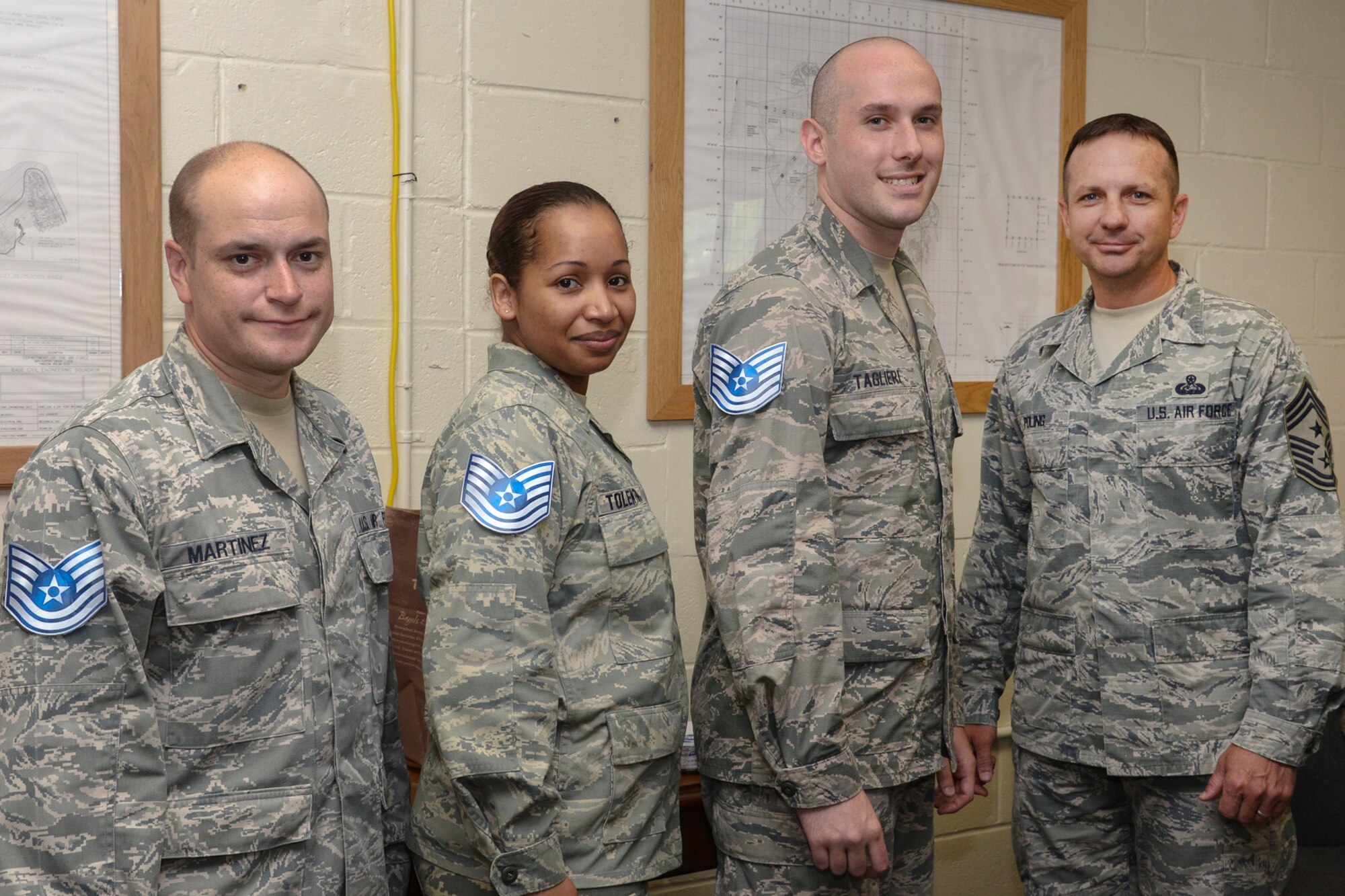 HANSCOM AIR FORCE BASE, Mass. – Command Chief Master Sgt. Craig A. Poling stands alongside Tech. Sgt. selects Luis R. Martinez, Olga M. Tolentino and Shayne M. Taglieri after the three learned of their promotion. Congratulate Hanscom's newest technical sergeants with a "like." Air Force officials selected 6,684 of 38,344 eligible staff sergeants for promotion to technical sergeant for a selection rate of 17.43 percent. (U.S. Air Force photo by Walter Santos)