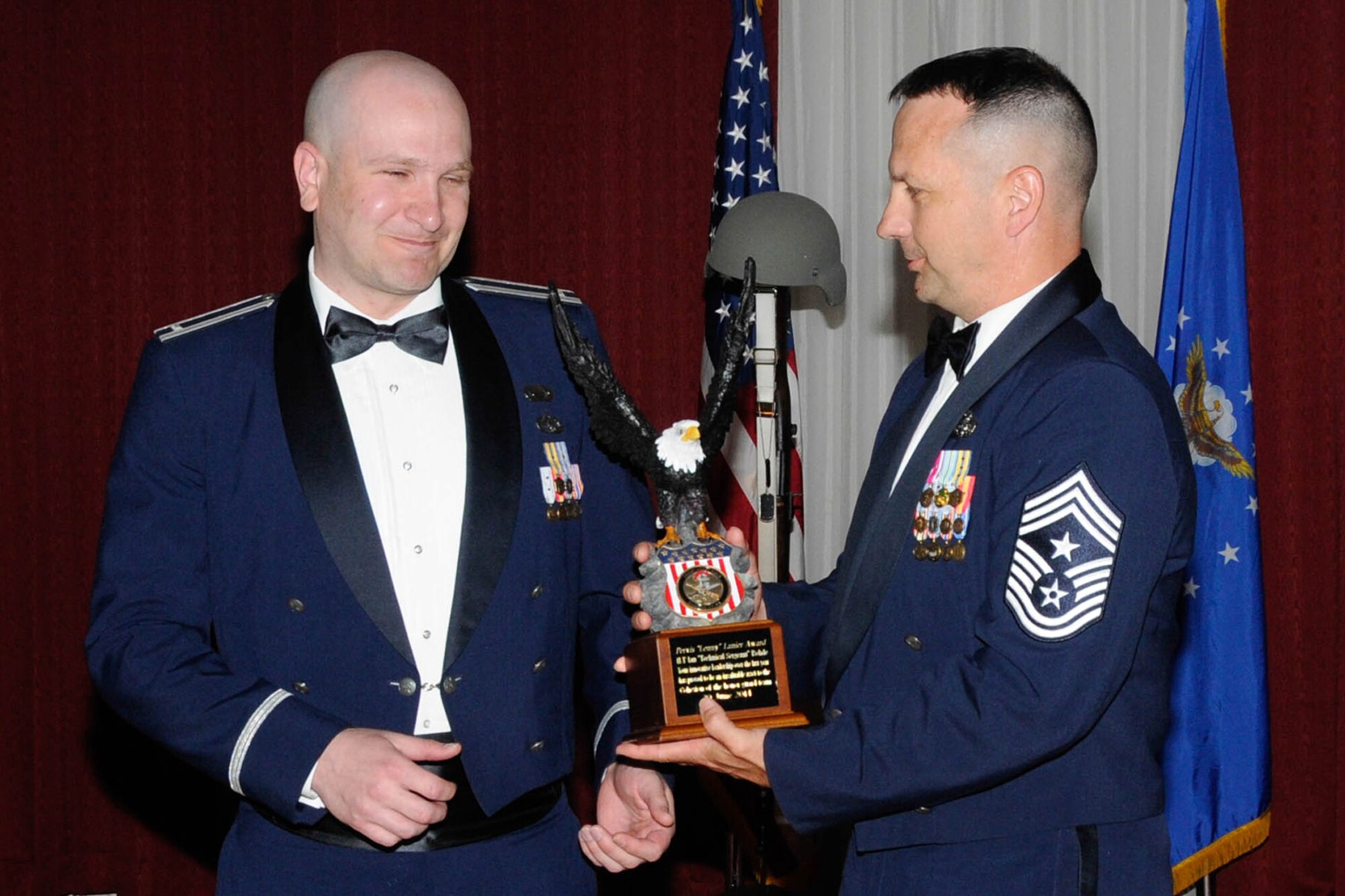 HANSCOM AIR FORCE BASE, Mass. – Command Chief Master Sgt. Craig A Poling presents 1st Lt. Ian Rohde the Master Sgt. Lenny Lanier Award for 2013 during the Honor Guard Appreciation Banquet at the Minuteman Commons June 20. The award recognizes the Patriot Honor Guard member most ready to give of himself to help others. Rohde participated in 86 military funerals last year. (U.S. Air Force photo by Linda LaBonte Britt)
