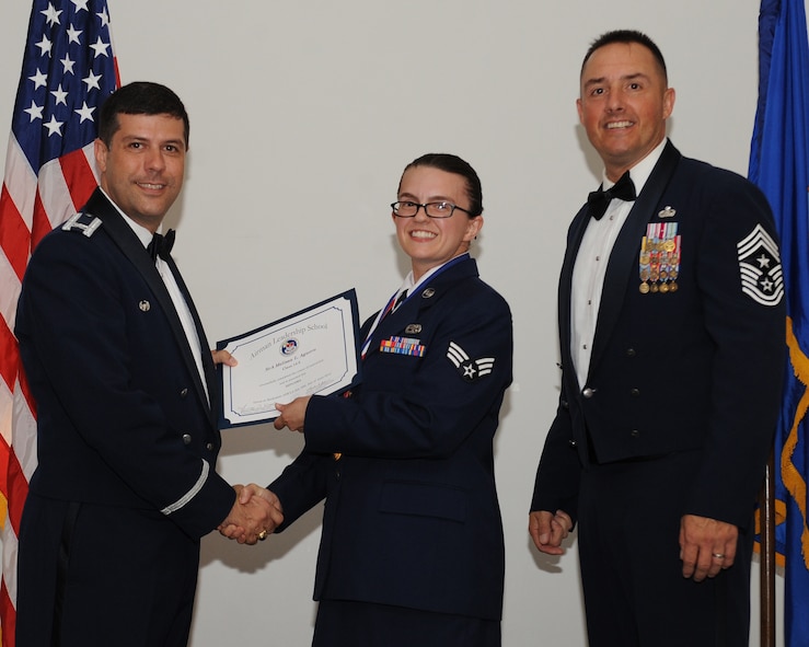 Senior Airman Melissa Aguero, 2nd Maintenance Squadron, receives an Airman Leadership School graduation certificate from Col. Andrew Gebara, 2nd Bomb Wing commander, during the ALS Class 14-5 Graduation on Barksdale Air Force Base, La., June 19, 2014. (U.S. Air Force photo/Senior Airman Benjamin Gonsier)