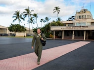 Col. Johnny Roscoe, 15th Wing commander, leaves base operations in preparation for his final training mission aboard a C-17 Globemaster III June 24, 2014. A pilot’s final flight, or “fini-flight,” is a farewell tradition for Air Force pilots. Roscoe is retiring after 26 years of commissioned service. (U.S. Air Force photo/Tech. Sgt. Terri Paden)