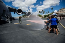 Col. Johnny Roscoe, 15th Wing commander, is hosed down by his family on the Joint Base Pearl Harbor-Hickam flightline after completing his final training mission in the C-17 Globemaster III June 24, 2014. The mission was Roscoe’s “fini-flight,” a ceremonial final flight for Air Force pilots. Roscoe is retiring after 26 years of Air Force service. (U.S. Air Force photo/Tech. Sgt. Terri Paden)