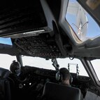 Col. Johnny Roscoe, 15th Wing commander, guides a C-17 Globemaster III into position to receive fuel from a KC-135 Stratotanker during an in-air refueling training mission near Joint Base Pearl Harbor-Hickam, Hawaii, June 24, 2014. The mission was Roscoe’s “fini-flight,” a ceremonial final flight for Air Force pilots. Roscoe is retiring after 26 years of Air Force service. (U.S. Air Force photo/Tech. Sgt. Terri Paden)