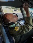 Col. Johnny Roscoe, 15th Wing commander, conducts a pre-flight checklist for a C-17 Globemaster III on the Joint Base Pearl Harbor-Hickam flightline before taking off on his “fini-flight” June 24, 2014. A “fini-flight” is a ceremonial final flight for Air Force pilots. Roscoe will retire June 26 after 26 years of Air Force service. (U.S. Air Force photo/Tech. Sgt. Terri Paden)