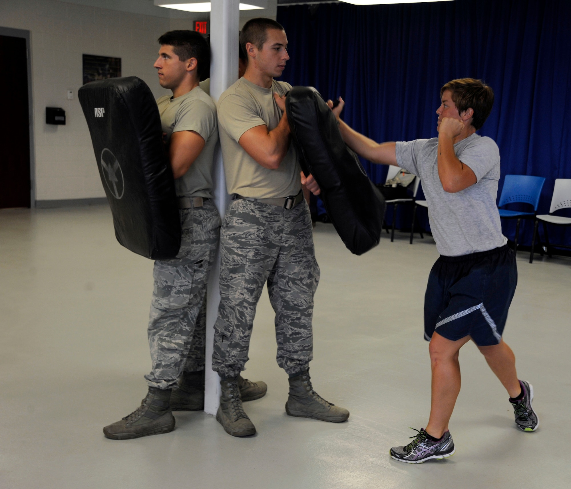 Airman 1st Class Whitney Miller, 6th Security Forces base defense operations center alarm monitor, performs baton training at MacDill Air Force Base, Fla., June 26, 2014. Miller is in a three week apprenticeship to become a Phoenix Raven. (U.S. Air Force photo by Airman 1st Class Tori Schultz/Released)  