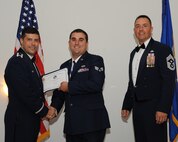 Senior Airman Gregory Ward, 2nd Aircraft Maintenance Squadron, receives an Airman Leadership School graduation certificate from Col. Andrew Gebara, 2nd Bomb Wing commander, during the ALS Class 14-5 Graduation on Barksdale Air Force Base, La., June 19, 2014. (U.S. Air Force photo/Senior Airman Benjamin Gonsier)