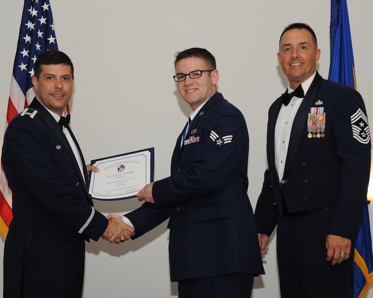 Senior Airman Cody Schillinger, 2nd Maintenance Squadron, receives an Airman Leadership School graduation certificate from Col. Andrew Gebara, 2nd Bomb Wing commander, during the ALS Class 14-5 Graduation on Barksdale Air Force Base, La., June 19, 2014. (U.S. Air Force photo/Senior Airman Benjamin Gonsier)