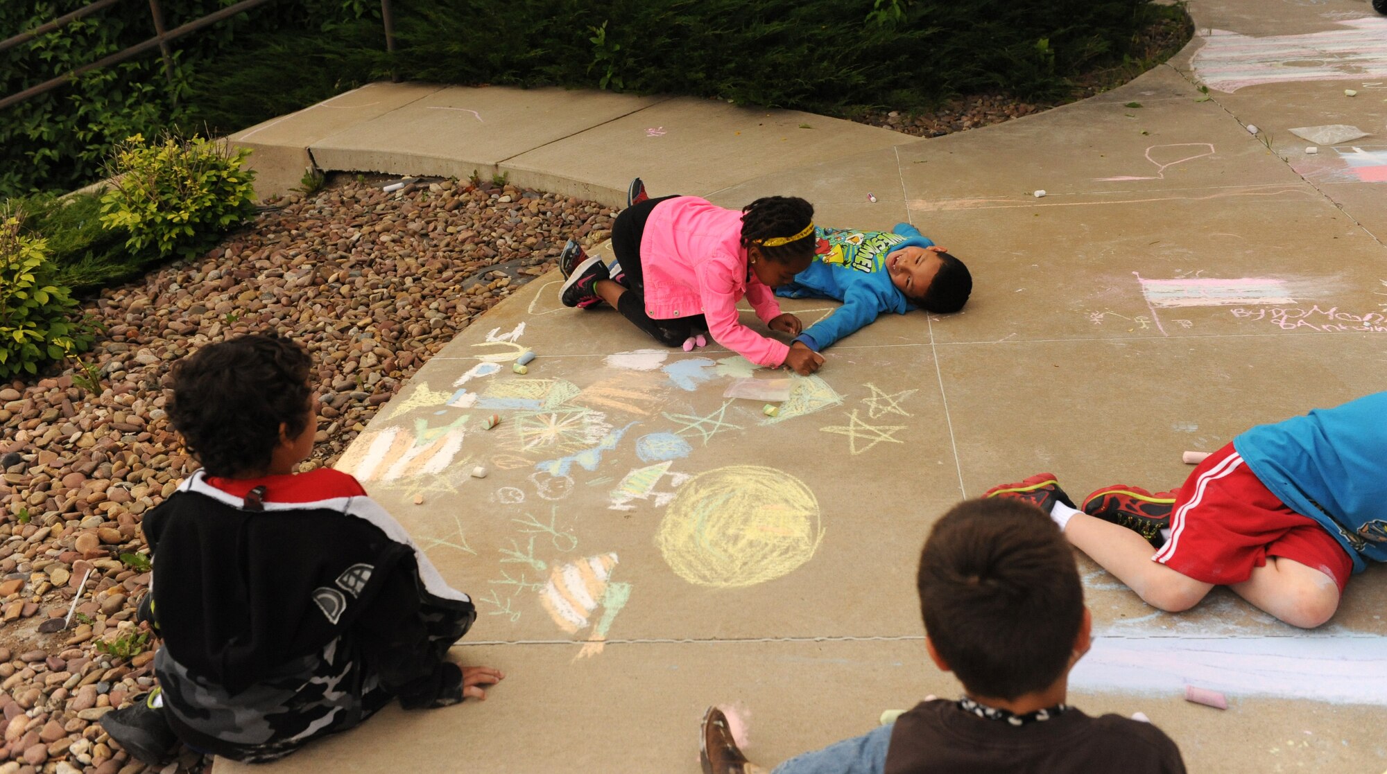 Children show their creative and artistic skills during the 15th annual Chalk It Up sidewalk chalk art competition June 26 at Malmstrom Air Force Base Youth Center. The competition was open to all youth and families and participants were treated with a free barbecue. (U.S. Air Force photo/ Airman 1st Class Joshua Smoot)