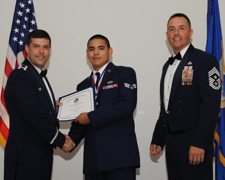 Senior Airman Nicholas Rivas, 2nd Maintenance Squadron, receives an Airman Leadership School graduation certificate from Col. Andrew Gebara, 2nd Bomb Wing commander, during the ALS Class 14-5 Graduation on Barksdale Air Force Base, La., June 19, 2014. (U.S. Air Force photo/Senior Airman Benjamin Gonsier)