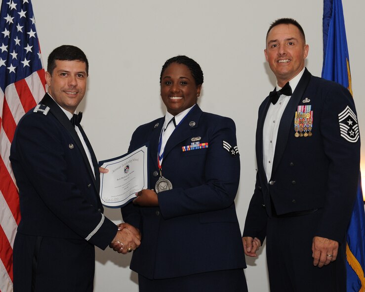 Senior Airman Phylicia Portlow, Air Combat Command Training Support Squadron Detachment 13, receives an Airman Leadership School graduation certificate from Col. Andrew Gebara, 2nd Bomb Wing commander, during the ALS Class 14-5 Graduation on Barksdale Air Force Base, La., June 19, 2014. (U.S. Air Force photo/Senior Airman Benjamin Gonsier)