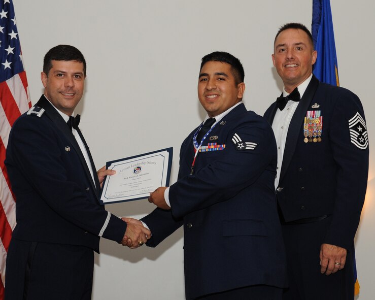 Senior Airman Victor Martinez, 2nd Maintenance Squadron, receives an Airman Leadership School graduation certificate from Col. Andrew Gebara, 2nd Bomb Wing commander, during the ALS Class 14-5 Graduation on Barksdale Air Force Base, La., June 19, 2014. (U.S. Air Force photo/Senior Airman Benjamin Gonsier)