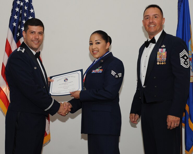 Senior Airman Alejandra Laguna, 2nd Maintenance Group, receives an Airman Leadership School graduation certificate from Col. Andrew Gebara, 2nd Bomb Wing commander, during the ALS Class 14-5 Graduation on Barksdale Air Force Base, La., June 19, 2014. (U.S. Air Force photo/Senior Airman Benjamin Gonsier)