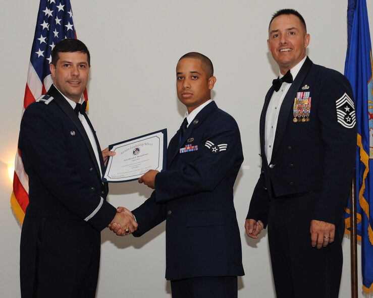 Senior Airman David Humphreys, 2nd Maintenance Group, receives an Airman Leadership School graduation certificate from Col. Andrew Gebara, 2nd Bomb Wing commander, during the ALS Class 14-5 Graduation on Barksdale Air Force Base, La., June 19, 2014. (U.S. Air Force photo/Senior Airman Benjamin Gonsier)