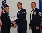 Senior Airman Ron Hoefler, 2nd Aircraft Maintenance Squadron, receives an Airman Leadership School graduation certificate from Col. Andrew Gebara, 2nd Bomb Wing commander, during the ALS Class 14-5 Graduation on Barksdale Air Force Base, La., June 19, 2014. (U.S. Air Force photo/Senior Airman Benjamin Gonsier)