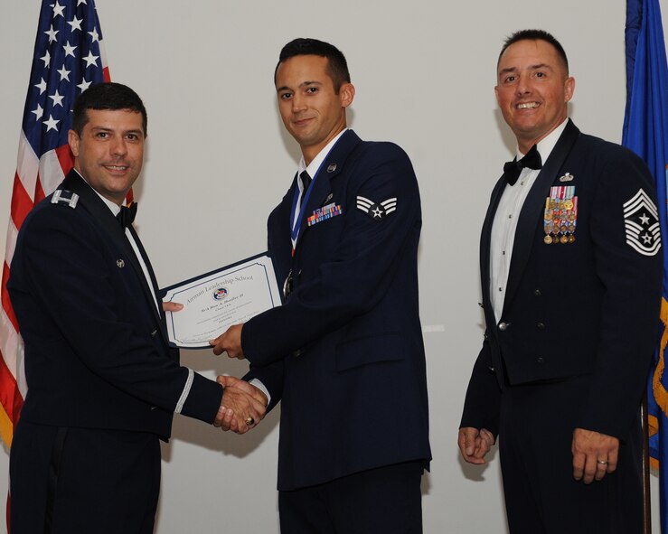 Senior Airman Ron Hoefler, 2nd Aircraft Maintenance Squadron, receives an Airman Leadership School graduation certificate from Col. Andrew Gebara, 2nd Bomb Wing commander, during the ALS Class 14-5 Graduation on Barksdale Air Force Base, La., June 19, 2014. (U.S. Air Force photo/Senior Airman Benjamin Gonsier)