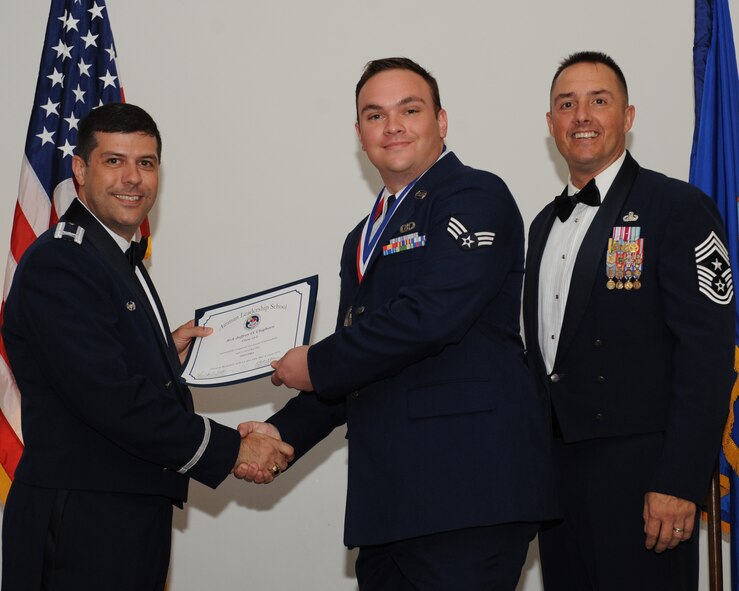 Senior Airman Jeffrey Cleghorn, 2nd Operations Support Squadron, receives an Airman Leadership School graduation certificate from Col. Andrew Gebara, 2nd Bomb Wing commander, during the ALS Class 14-5 Graduation on Barksdale Air Force Base, La., June 19, 2014. (U.S. Air Force photo/Senior Airman Benjamin Gonsier)