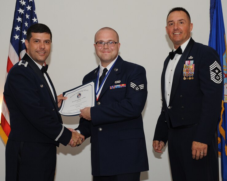 Senior Airman Christopher Ries, 2nd Communications Squadron, receives an Airman Leadership School graduation certificate from Col. Andrew Gebara, 2nd Bomb Wing commander, during the ALS Class 14-5 Graduation on Barksdale Air Force Base, La., June 19, 2014. (U.S. Air Force photo/Senior Airman Benjamin Gonsier)