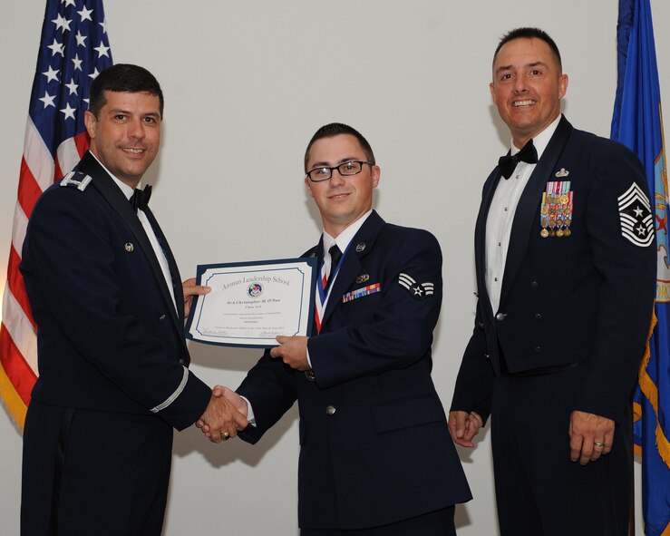 Senior Airman Christopher O?Nan, 2nd Munitions Squadron, receives an Airman Leadership School graduation certificate from Col. Andrew Gebara, 2nd Bomb Wing commander, during the ALS Class 14-5 Graduation on Barksdale Air Force Base, La., June 19, 2014. (U.S. Air Force photo/Senior Airman Benjamin Gonsier)