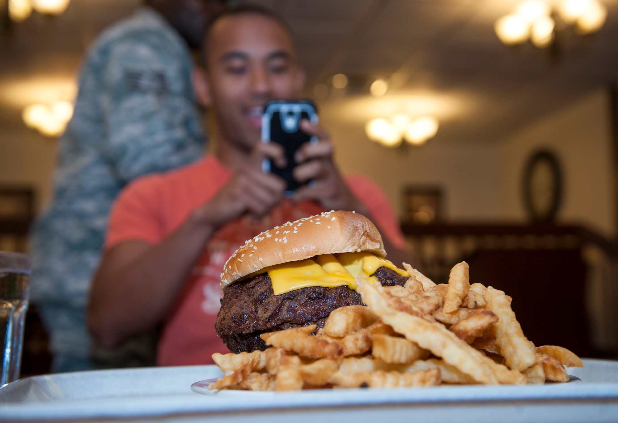 The 2.5-pound monster burger is revealed before the start of a Man vs. Food competition at Moody Air Force Base, Ga., June 25, 2014. U.S. Air Force Senior Airman Arthur Williams, 23d Force Support Squadron food services specialist, organized the competition and cooked the four 2.5-pound burgers by searing them first and then baking them to get them to the correct temperature. (U.S. Air Force photo by Senior Airman Jarrod Grammel/Released)
