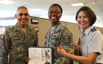 Air Force District of Washington Commander Maj. Gen. Sharon K. G. Dunbar and AFDW Command Chief Master Sgt. Jose LugoSantiago congratulate Staff Sgt. Barrita Simmons for being selected for promotion to technical sergeant at Joint Base Andrews, Maryland, June 26, 2014. Simmons is the AFDW Manpower, Personnel, Services NCOIC of command decorations. (U.S. Air Force photo/Master Sgt. Tammie Moore)