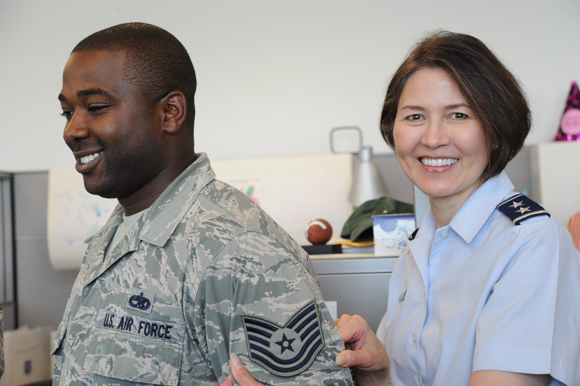 Air Force District of Washington Commander Maj. Gen. Sharon K. G. Dunbar congratulates Staff Sgt. Chris White for being selected for promotion to technical sergeant at Joint Base Andrews, Maryland, June 26, 2014. White is the AFDW Command’s Support Staff unit training manager. (U.S. Air Force photo/Master Sgt. Tammie Moore)