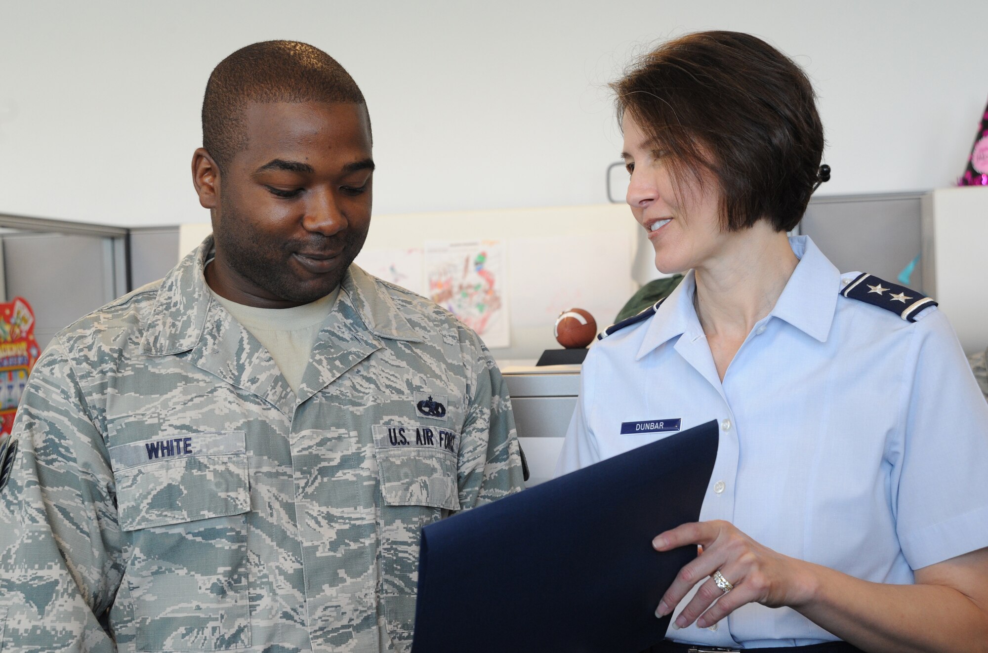 Air Force District of Washington Commander Maj. Gen. Sharon K. G. Dunbar congratulates Staff Sgt. Chris White for being selected for promotion to technical sergeant at Joint Base Andrews, Maryland, June 26, 2014. White is the AFDW Command’s Support Staff unit training manager. (U.S. Air Force photo/Master Sgt. Tammie Moore)