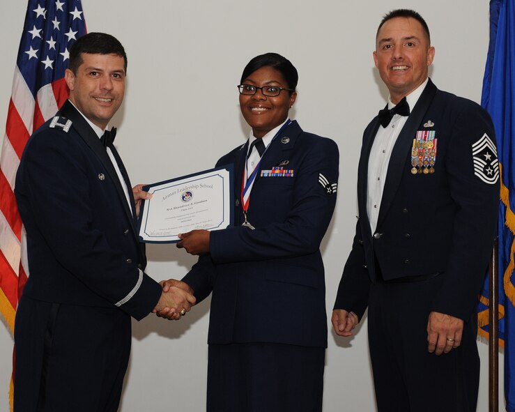 Senior Airman Shandrica Goodson, 96th Bomb Squadron, receives an Airman Leadership School graduation certificate from Col. Andrew Gebara, 2nd Bomb Wing commander, during the ALS Class 14-5 Graduation on Barksdale Air Force Base, La., June 19, 2014. (U.S. Air Force photo/Senior Airman Benjamin Gonsier)