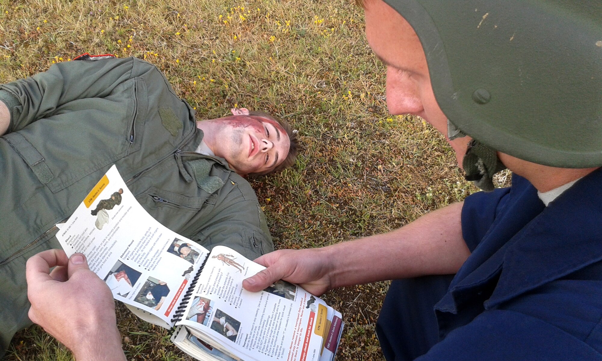 An Airman assesses a mock wound on a simulated victim during the 48th Fighter Wing’s mission assurance exercise at Royal Air Force Lakenheath, England, June 25, 2014. The exercise was designed to better prepare Airmen to respond to real-world crises and emergencies while also highlighting the importance of vigilance and safety. (U.S. Air Force photo by Tech. Sgt. Eric Burks/Released)