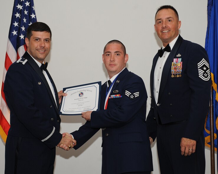 Senior Airman Steven Fodge, 2nd Aircraft Maintenance Squadron, receives an Airman Leadership School graduation certificate from Col. Andrew Gebara, 2nd Bomb Wing commander, during the ALS Class 14-5 Graduation on Barksdale Air Force Base, La., June 19, 2014. (U.S. Air Force photo/Senior Airman Benjamin Gonsier)