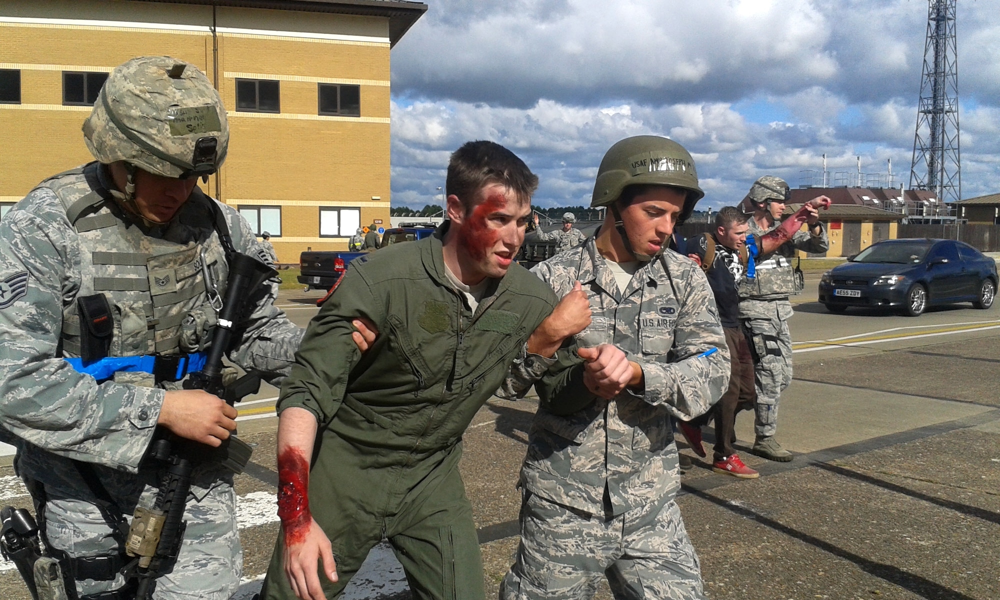 Exercise participants escort simulated victims to a casualty collection point during the 48th Fighter Wing’s mission assurance exercise at Royal Air Force Lakenheath, England, June 25, 2014. The exercise was designed to better prepare Airmen to respond to real-world crises and emergencies while also highlighting the importance of vigilance and safety. (U.S. Air Force photo by Tech. Sgt. Eric Burks/Released)