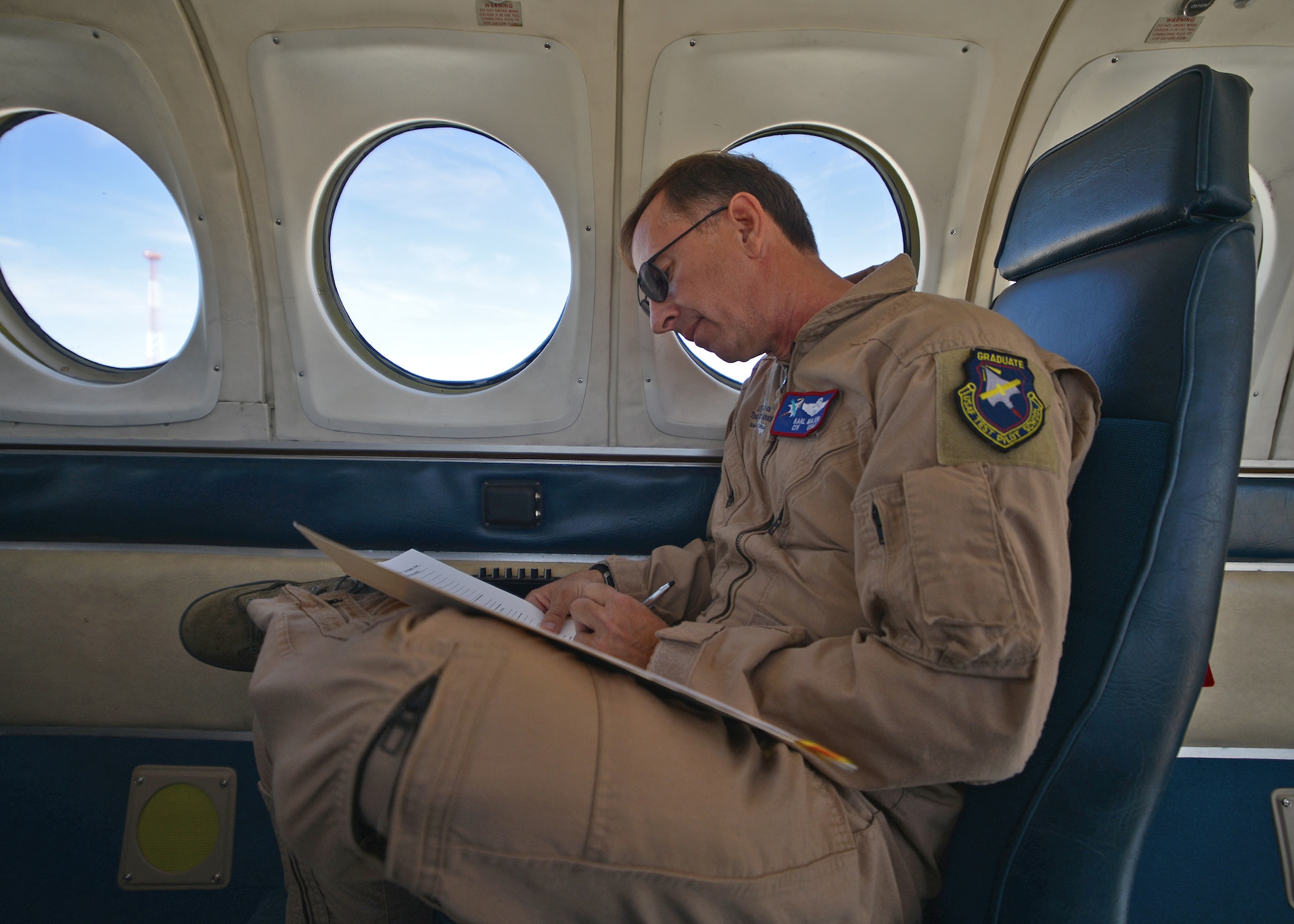 Karl Major, U.S. Air Force Test Pilot School instructor, signs off on post-aircraft condition inspection paperwork on an Edwards C-12C Huron, tail number 31215, after arriving from its ACI in San Angelo, Texas, on June 20. This specific C-12C was out for more than a year due to damage it incurred from a heavy hailstorm while undergoing its ACI. While in San Angelo, the aircraft underwent repairs on the exterior of the aircraft and received new mods in order to return as a test asset at Edwards. (U.S. Air Force photo by Jet Fabara)