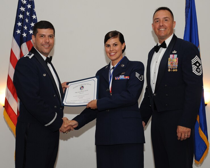 Staff Sgt. Amanda Clarke, 608th Air Operations Center, receives an Airman Leadership School graduation certificate from Col. Andrew Gebara, 2nd Bomb Wing commander, during the ALS Class 14-5 Graduation on Barksdale Air Force Base, La., June 19, 2014. (U.S. Air Force photo/Senior Airman Benjamin Gonsier)