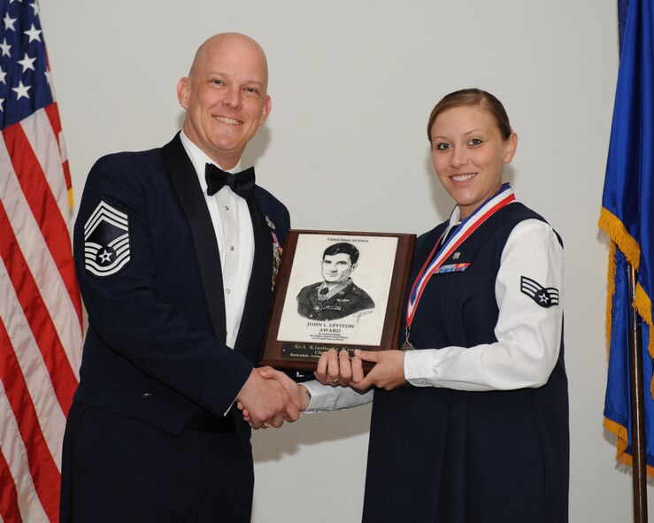 Senior Airman Kimberly Kruse, 2nd Medical Operations Squadron, receives the John L. Levitow Award from Chief Master Sgt. Timothy Gibson, 2nd Operations Support Squadron, during the Airman Leadership School Class 14-5 Graduation on Barksdale Air Force Base, La., June 19, 2014. (U.S. Air Force photo/Senior Airman Benjamin Gonsier)