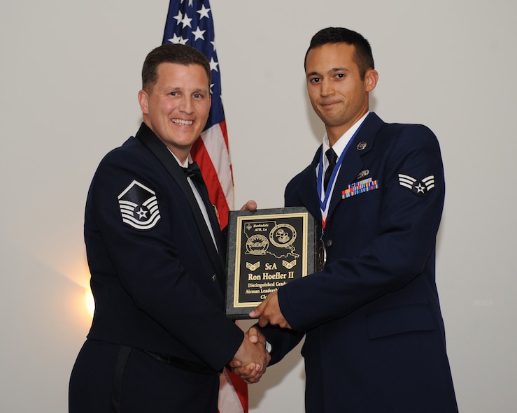 Senior Airman Ron Hoefler, 2nd Aircraft Maintenance Squadron, receives the Distinguished Graduate Award from Master Sgt. Joshua Sandifer, 2nd Maintenance Squadron, during the Airman Leadership School Class 14-5 Graduation on Barksdale Air Force Base, La., June 19, 2014. (U.S. Air Force photo/Senior Airman Benjamin Gonsier)