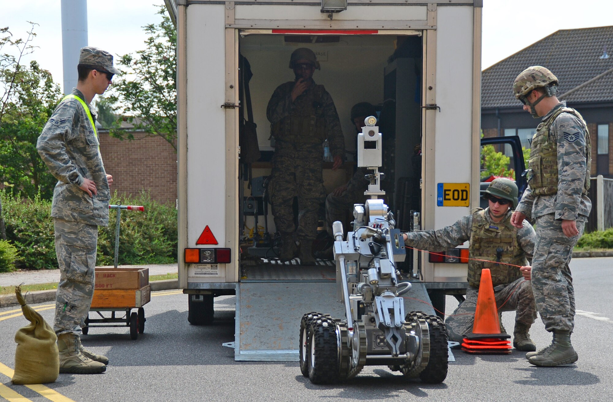 Explosive Ordnance technicians from the 48th Civil Engineer Squadron prepare to send an F6-A robot into a building to inspect a suspicious package during a mission assurance exercise at Royal Air Force Lakenheath, England, June 24, 2014. The exercise was designed to emphasize the importance of combat skills effectiveness training and ensure 48th Fighter Wing Airmen are fully prepared for any contingencies. (U.S. Air Force photo by Airman 1st Class Erin O’Shea/Released)
