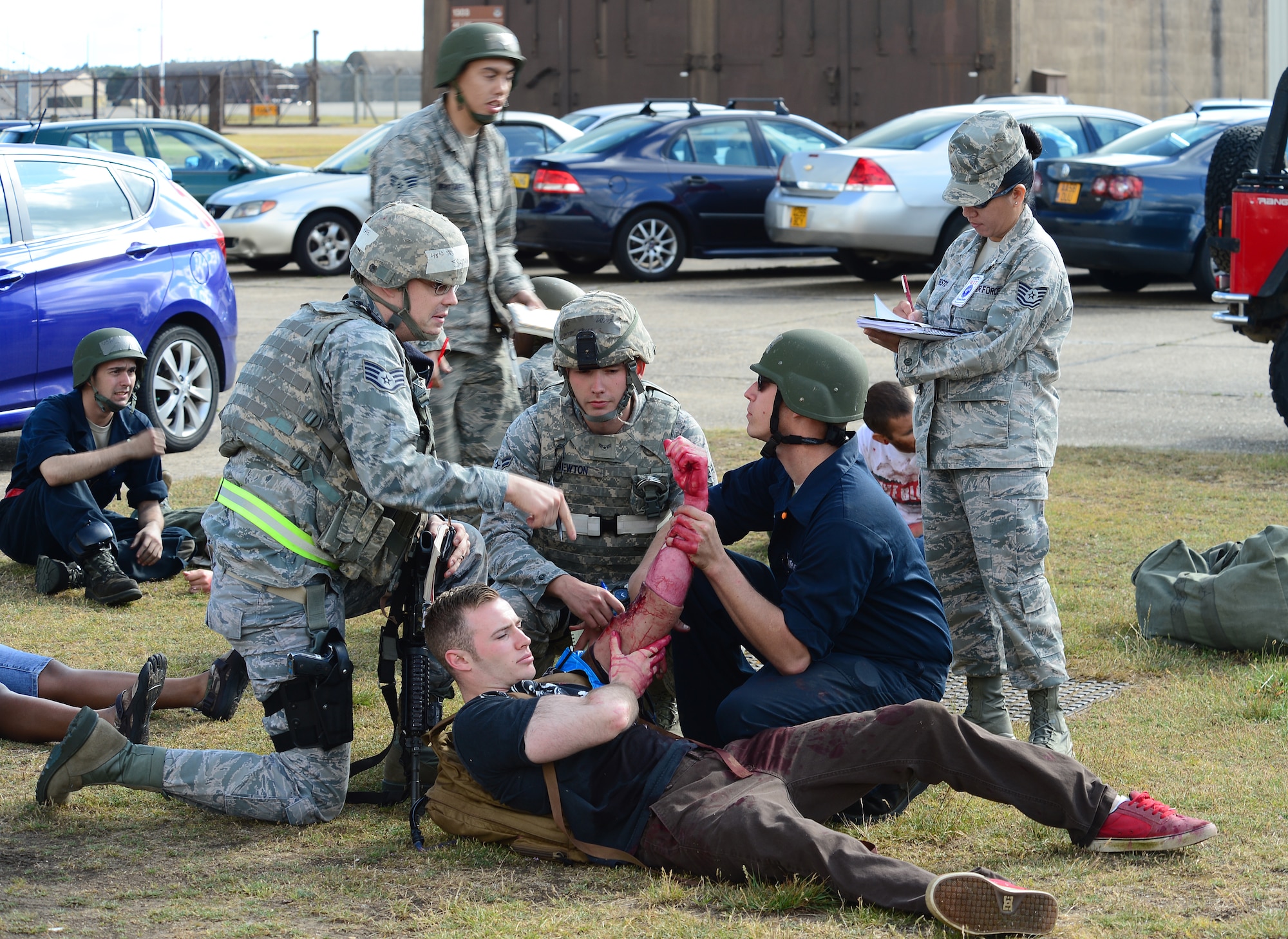 Exercise participants assess a mock wound on a simulated victim during the 48th Fighter Wing’s mission assurance exercise at Royal Air Force Lakenheath, England, June 25, 2014. The exercise was designed to better prepare Airmen to respond to real-world crises and emergencies while also highlighting the importance of vigilance and safety. (U.S. Air Force photo by Airman 1st Class Dana J. Butler/Released)