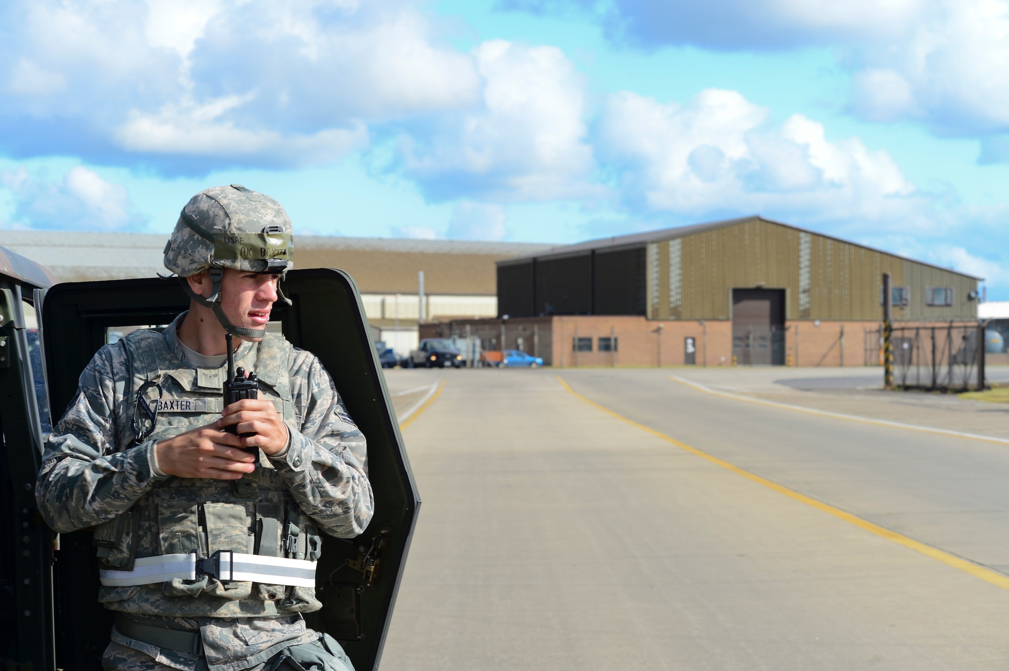 Airman 1st Class Sebastian Baxter, 48th Security Forces Squadron response force member, radios for assistance during the 48th Fighter Wing’s mission assurance exercise at Royal Air Force Lakenheath, England, June 25, 2014. The exercise was designed to better prepare Airmen to respond to real-world crises and emergencies while also highlighting the importance of vigilance and safety. (U.S. Air Force photo by Airman 1st Class Dana J. Butler/Released)