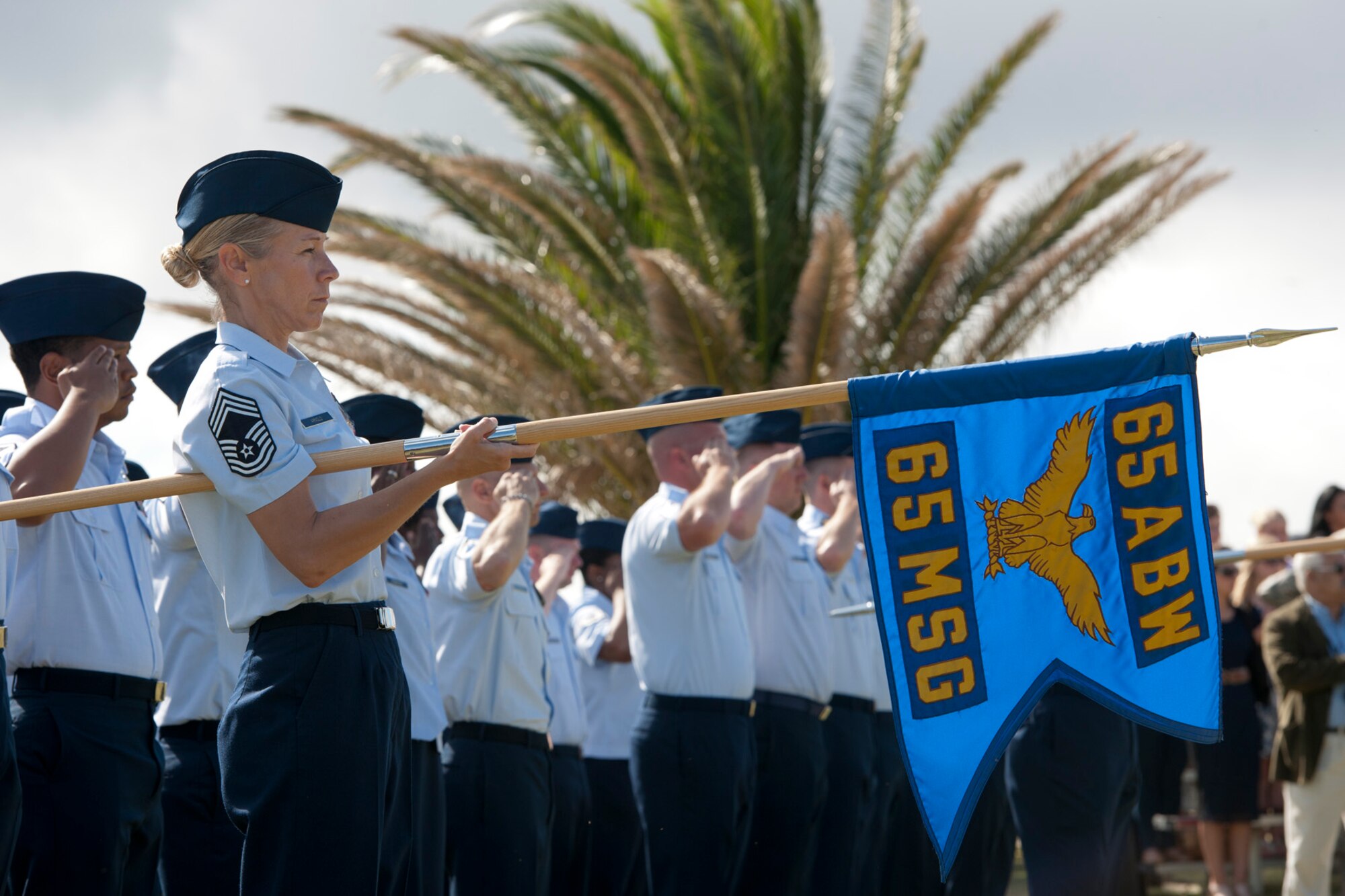 U.S. Air Force Chief Master Sgt. Lisa Arnold, 65th Mission Support Group superintendent, presents the 65th MSG guidon during a change of command ceremony June 26, 2014, Lajes Field, Azores, Portugal. Col. Martin Rothrock assumed command from Col. Chris Bargery, who had commanded the 65th ABW since July 2012.  Rothrock is a career security forces officer and arrives at Lajes Field from United States Forces in Korea.  (U.S. Air Force photo by Tech. Sgt. Paul Villanueva II/Released)