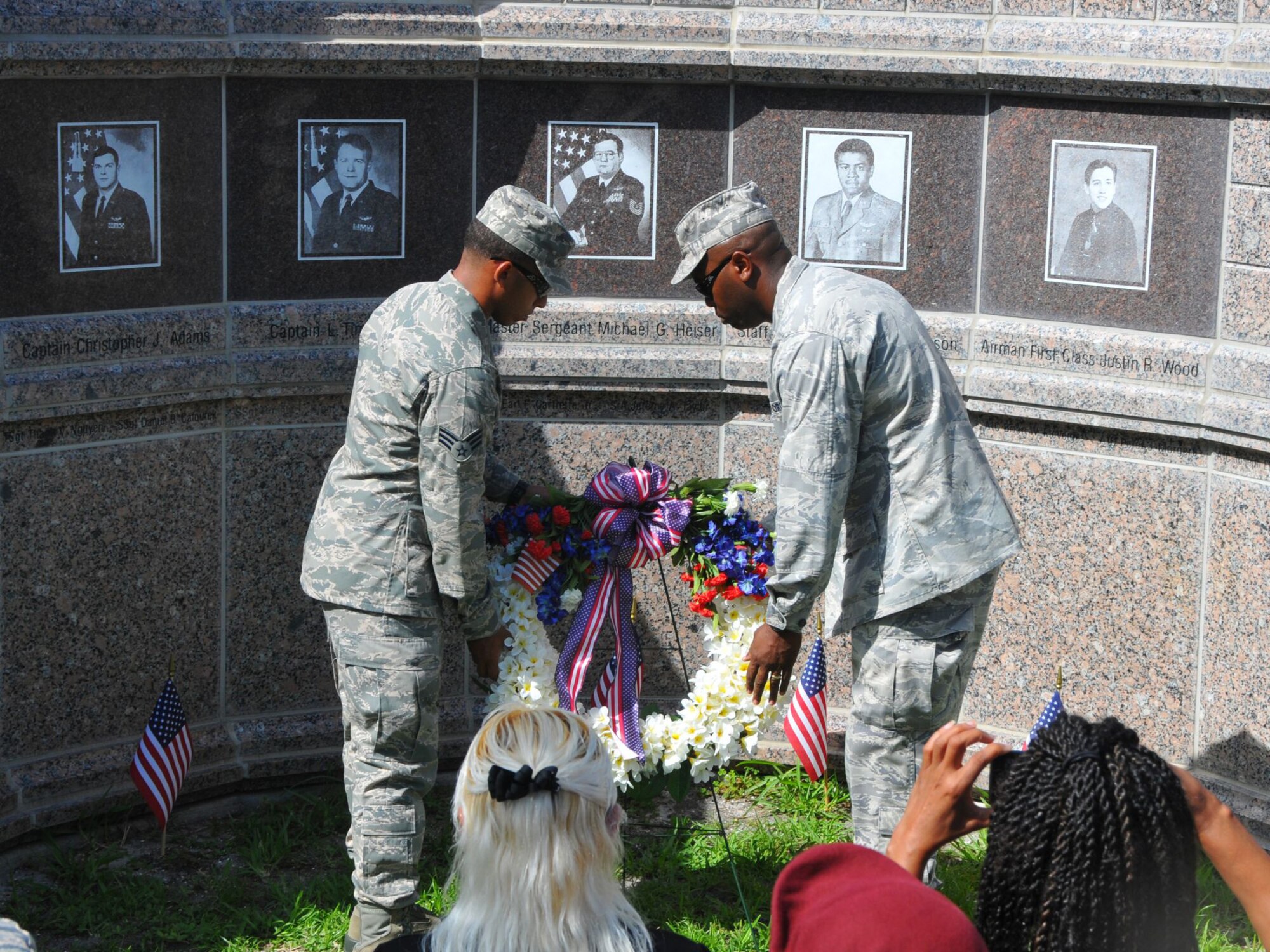 Senior Airman Felipe Guilfu (left) and Maj. Marcus Smith of the 920th Rescue Wing place a wreath at the Khobar Towers Memorial during a ceremony held here June 25 to commemorate the Airmen who lost their lives during the terrorist bombing at Khobar Towers, Saudi Arabia 18 years ago. (courtesy photo/Malcolm Denemark-Florida Today)