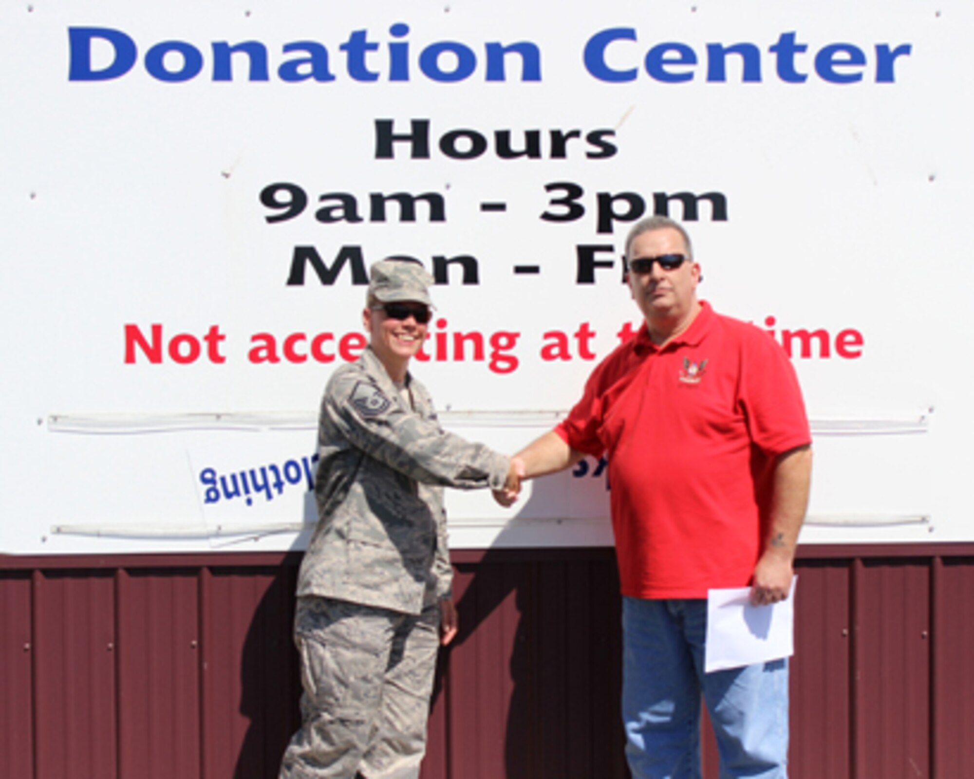 Steve Rippy, Home of the Brave house monitor and Air Force veteran of 10 years, thanks Master Sgt. Carrie Huot, 712th Aircraft Maintenance Squadron first sergeant, for donated items the 512th Airlift Wing Human Resources Development Council provided at the donation center in Milford, Del., June 8, 2014. The mission of the Home of the Brave is to reduce homelessness among military veterans.  In addition to providing transitional housing, food and security, they assist with employment, counseling services, access to healthcare, transportation and locating affordable housing. (U.S. Air Force photo/Herbert E. Welday III)