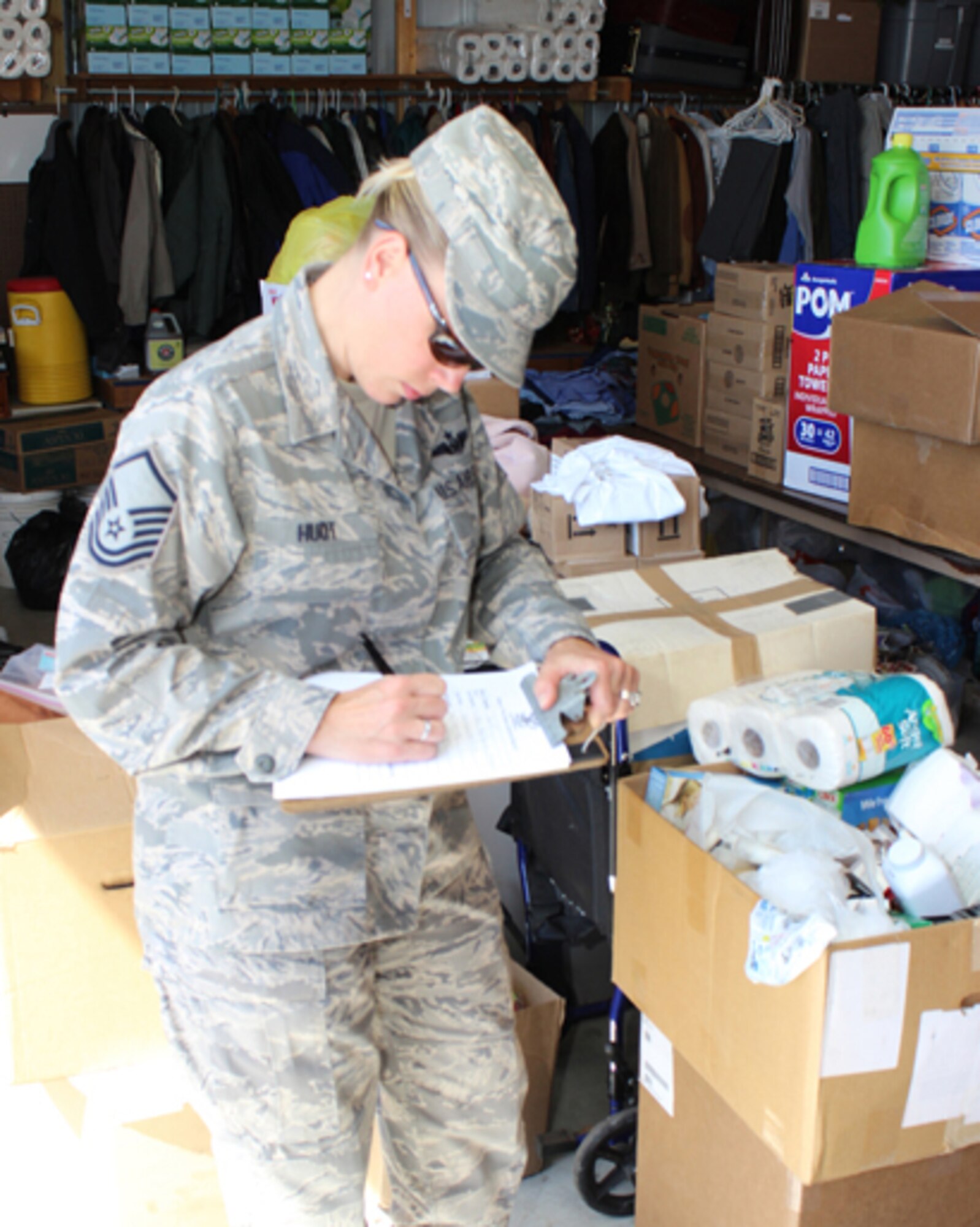 Master Sgt. Carrie Huot, 712th Aircraft Maintenance Squadron first sergeant, fills out donation forms at the Home of the Brave Donation Center in Milford, Del., June 8, 2014. Huot represented the 512th Airlift Wing Human Resources Development Council that provided needed items to the facility. The mission of the Home of the Brave is to reduce homelessness among military veterans.  In addition to providing transitional housing, food and security they assist with employment, counseling services, access to healthcare, transportation and locating affordable housing.  The goal of the Home of the Brave is to help veterans successfully transition into permanent housing and personal independence. (U.S. Air Force photo/Herbert E. Welday III)