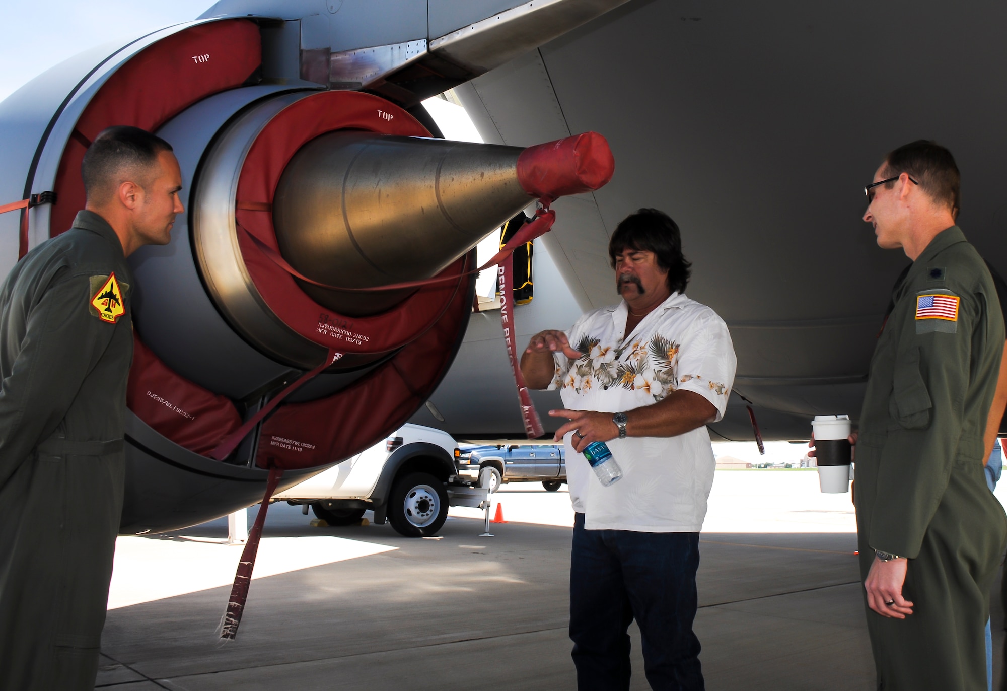 Tech. Sgt. Sean Gilson, left and Lt. Col. Marvin Ashbaker of the 465th Air Refueling Squadron listen to Mr. Phil Tinker talk about his days working on the F-108 engines, the same ones used on the KC-135R Stratotanker.  Tinker, the grandson of Maj. Gen. Clarence L. Tinker, flew in from his home in San Diego to attend the Star Spangled Salute June 21-22.  Maj. Gen. Tinker, an Oklahoma native, lost his life during World War II and, at the time was the highest ranking member of the U.S. Army to lose his life in combat.  On Oct. 14, 1942, the Oklahoma City Air Depot was renamed Tinker Field in honor Maj. Gen. Tinker.  Tinker AFB Star Spangled Salute open house marked the first time grandson, Phil has been to Oklahoma City since the bombing in 1995.  After the weekend’s activities, Tinker had an opportunity to tour the base as well as get a full tour of the 507th Air Refueling Wing’s KC-135.  (U.S. Air Force photo/Senior Airman Mark Hybers)