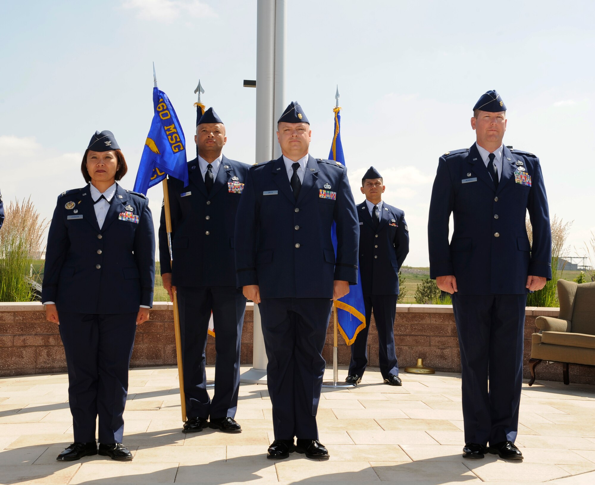 From left; Col. Rose Jourdan, 460th Mission Support Group commander; Chief Master Sgt. Ben Roberson, 460th MSG superintendent; Maj. Gene Smith, 460th Contracting Flight commander; and Maj. Jeremy Morrill stand at attention during the 460th CONF Change of Command Ceremony June 24, 2014, at the 460th Space Wing headquarters building on Buckley Air Force Base, Colo. The event signals Smith's assumption of command from Morrill. (U.S. Air Force photo by Airman 1st Class Samantha Saulsbury/Released)
