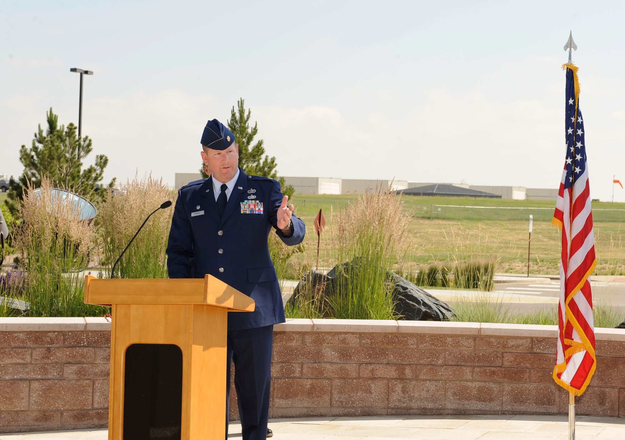 Maj. Jeremy Morrill addresses the crowd during the 460th Contracting Flight Change of Command Ceremony June 24, 2014, at the 460th Space Wing headquarters building on Buckley Air Force Base, Colo. Morrill served as the 460th CONF commander since July 2012, where he successfully led his flight through many challenges. (U.S. Air Force photo by Airman 1st Class Samantha Saulsbury/Released)