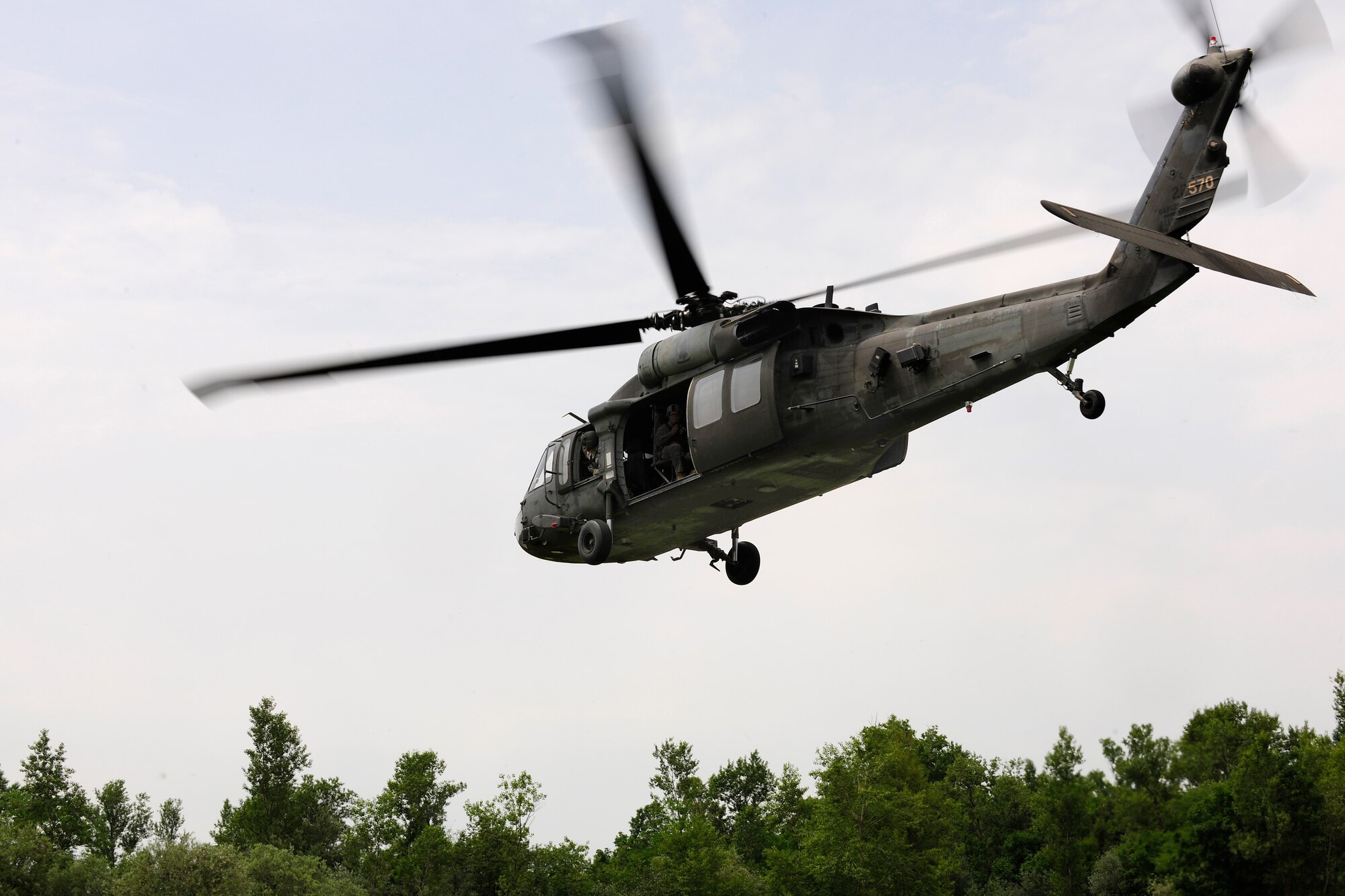 A U.S. Army UH-60 Black Hawk helicopter approaches the landing zone during a combat search and rescue training mission, June 24, 2014, at Cellina Meduna training ground near Maniago, Italy. Establishing a good relationship with other branches of the U.S. military helps mitigate risk and confusion in the event of a real-life situation requiring military intervention and assistance. (U.S. Air Force photo/Airman 1st Class Ryan Conroy) 
